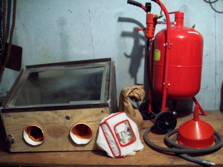 A collection of sandblasting equipment used for cleaning.