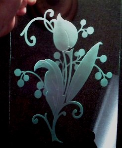 A glass sandcarving with a sandblaster.