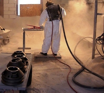 Picture of a man using sandblaster rental equipment.