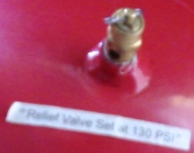 A sandblaster relief valve part used on a pressure pot tank.