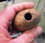 Rock with a hole in it potential blasted with sand.